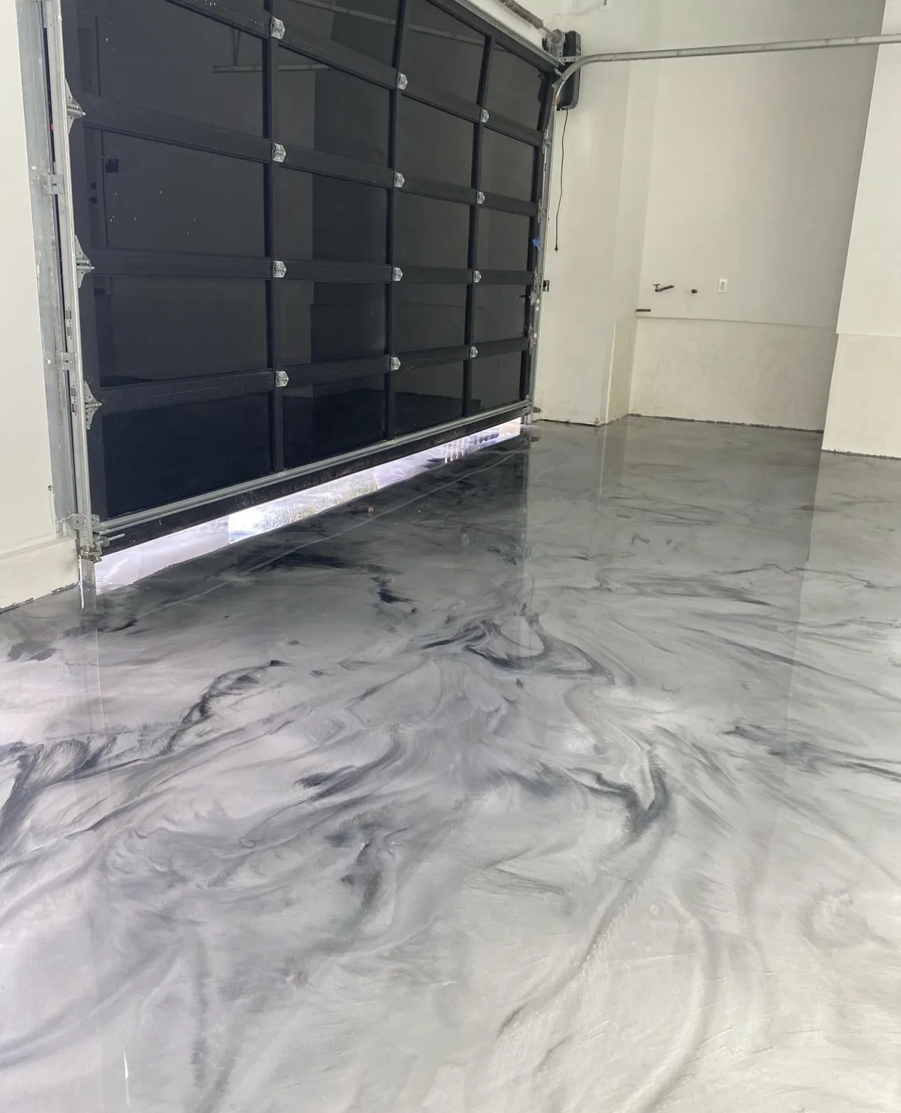 Silver and black swirled metallic epoxy garage floor
