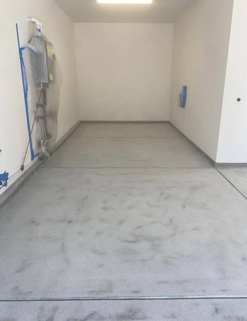 Bare prepped concrete garage before epoxy flake coating