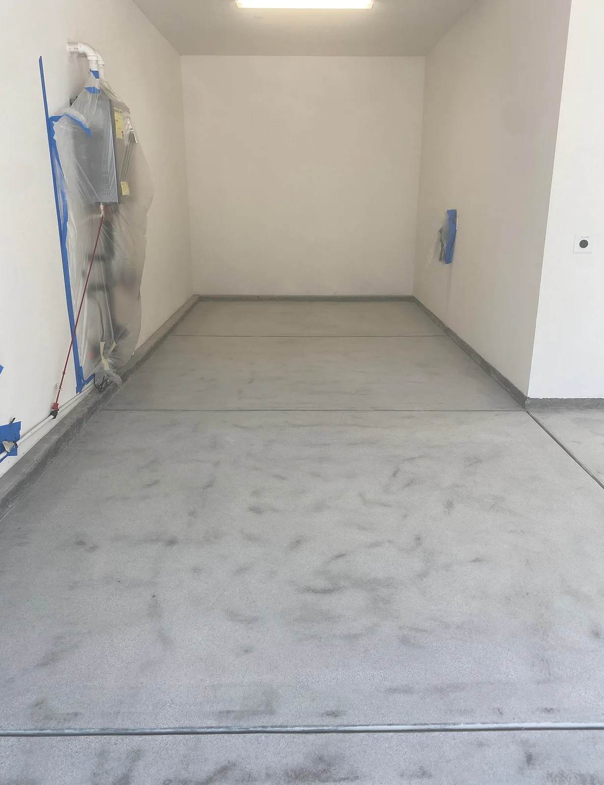 Bare prepped concrete garage before epoxy flake coating