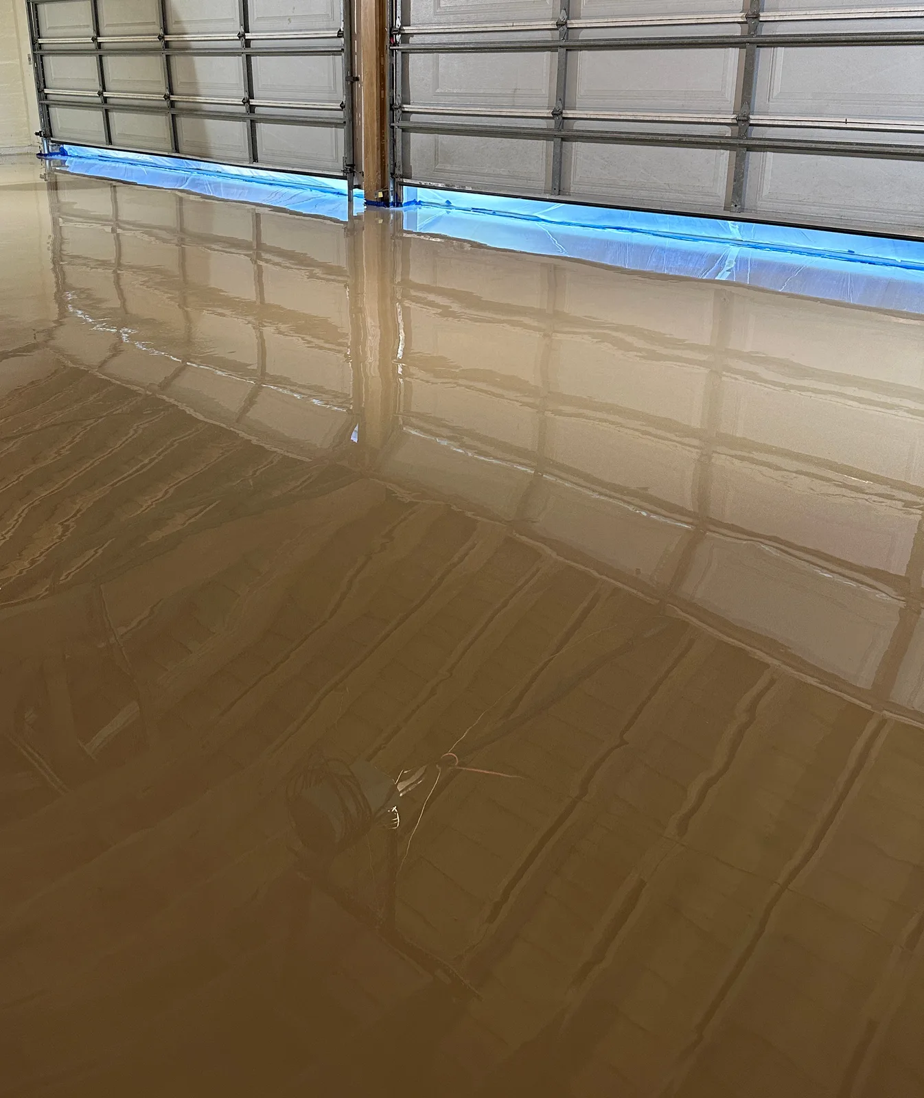Glossy tan solid-color epoxy garage floor