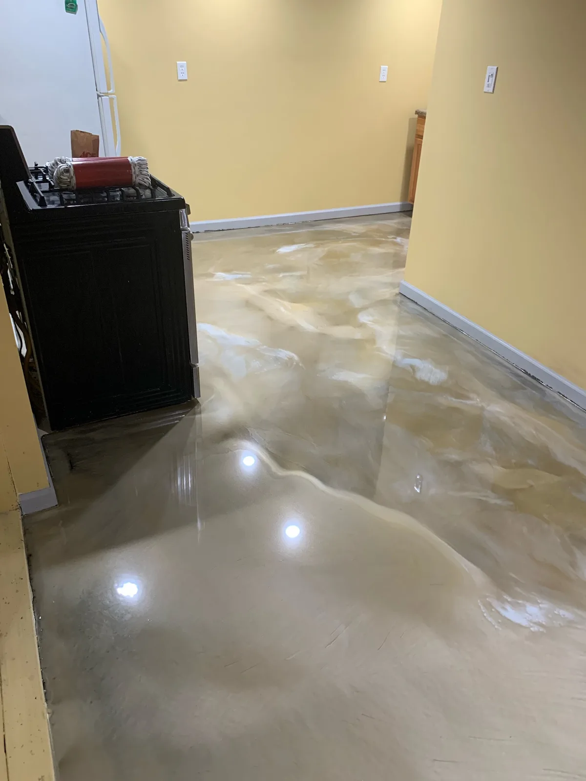 Cream and tan marbled metallic epoxy floor in a kitchen