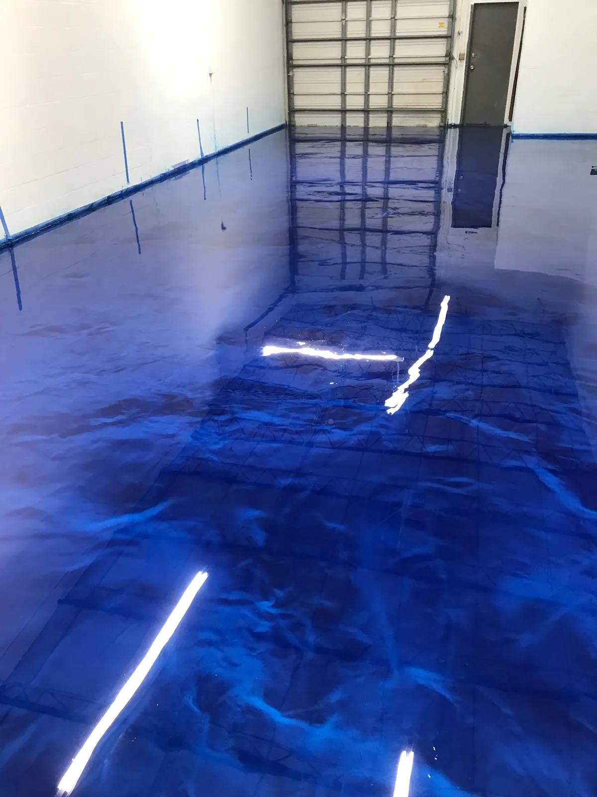 Deep blue swirled metallic epoxy warehouse floor
