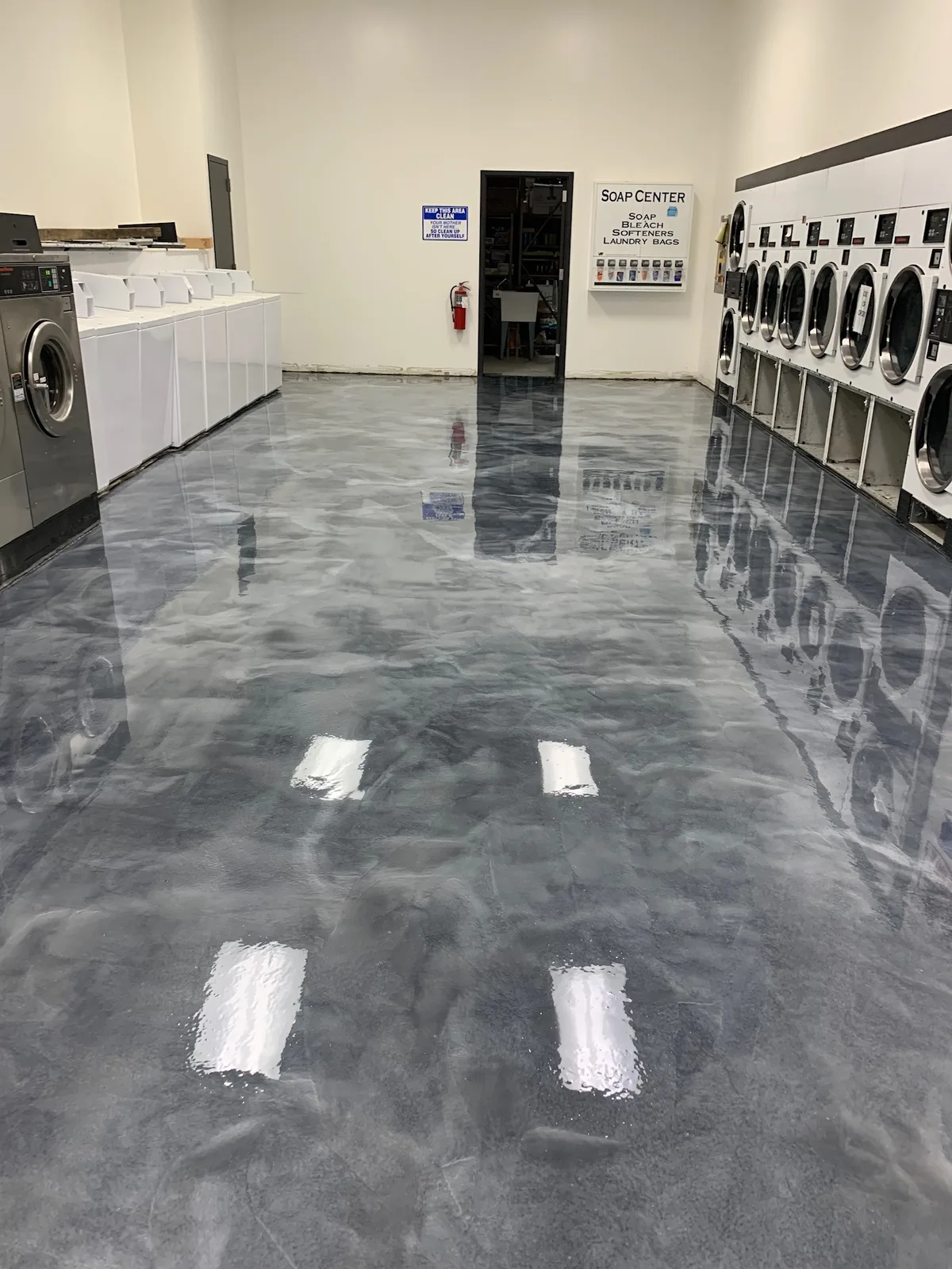 Swirled silver metallic epoxy floor in a coin laundromat