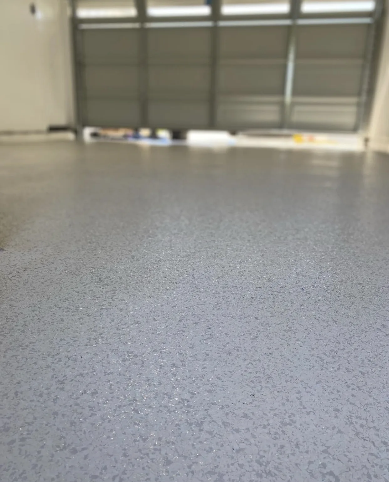 Gray flake epoxy garage floor in Los Angeles by Epoxy Experts Flooring