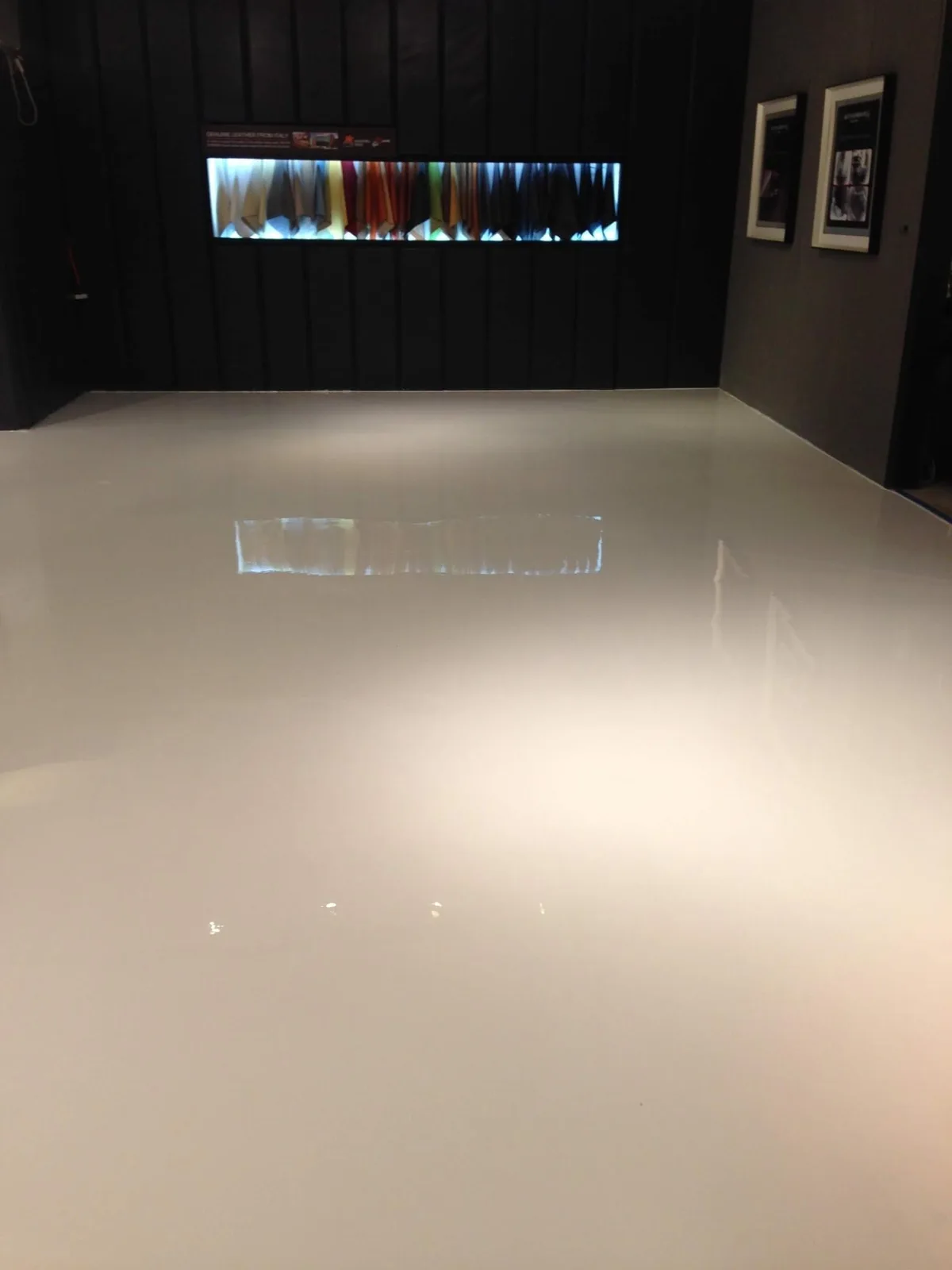 Bright white solid-color epoxy floor in a showroom
