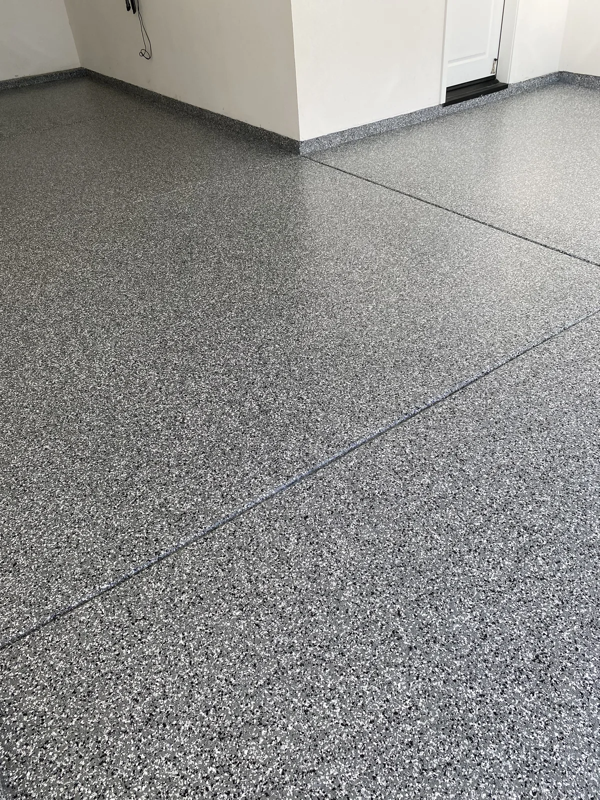 Granite-tone flake epoxy floor in a Santa Clarita garage